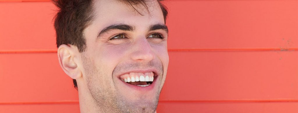 Stock image of a man smiling with wide mouth open