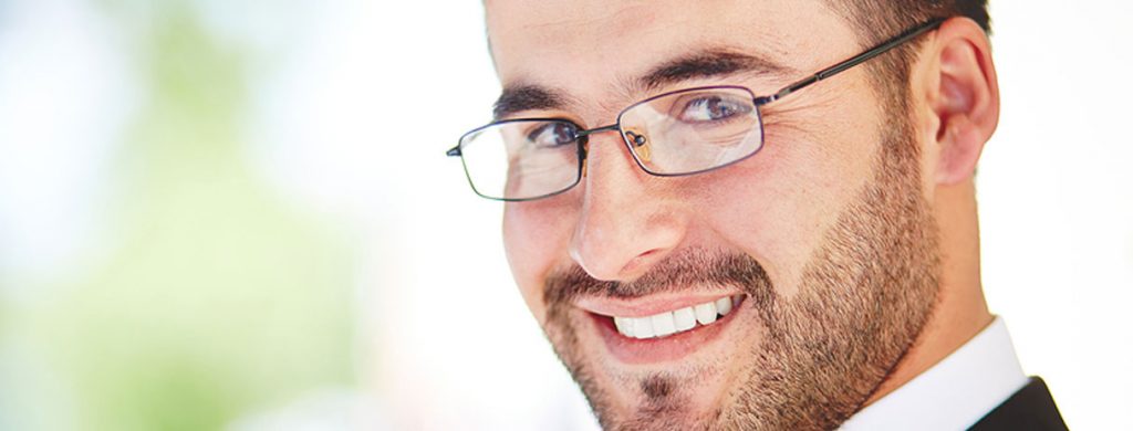 Stock image of man with glasses and smiling